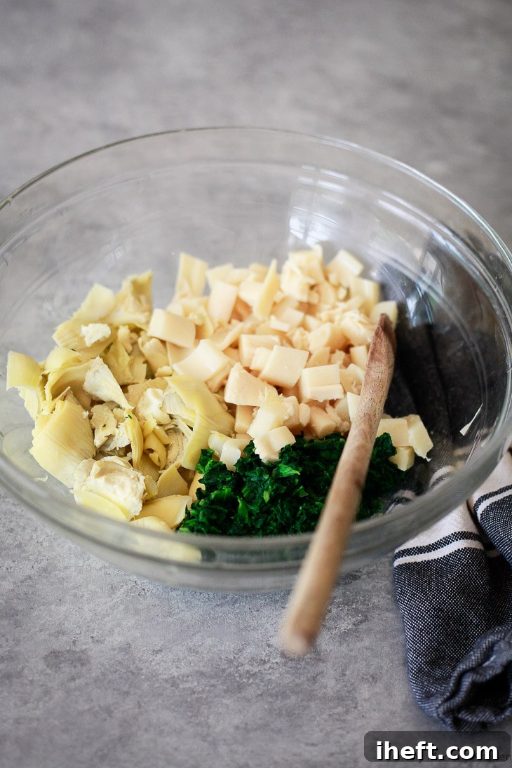 Ingredients for vegan spinach artichoke dip include artichokes, spinach, and hearts of palm. 