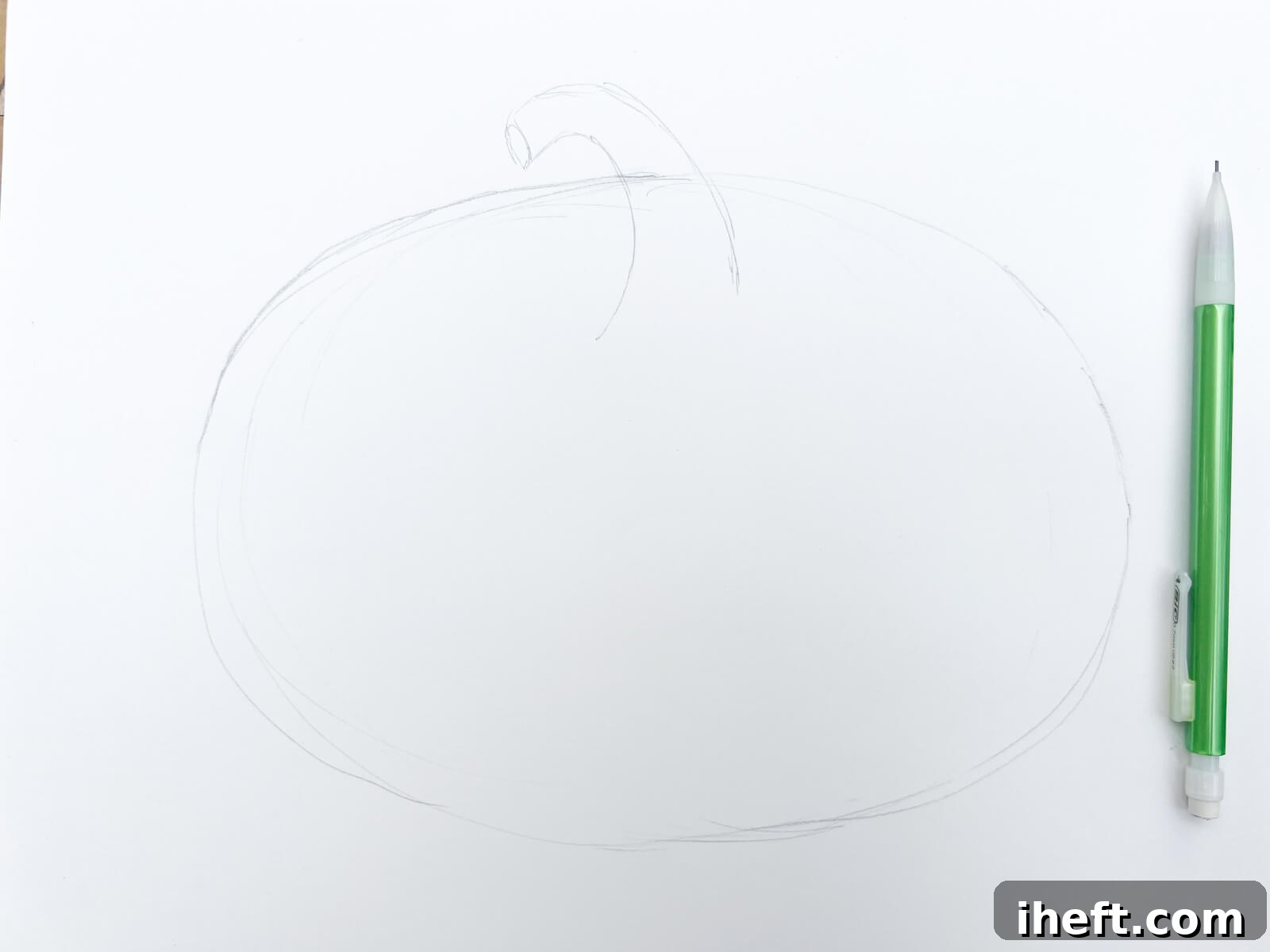 A light pencil sketch of an oval and a stem in the beginning stages of drawing a pumpkin.
