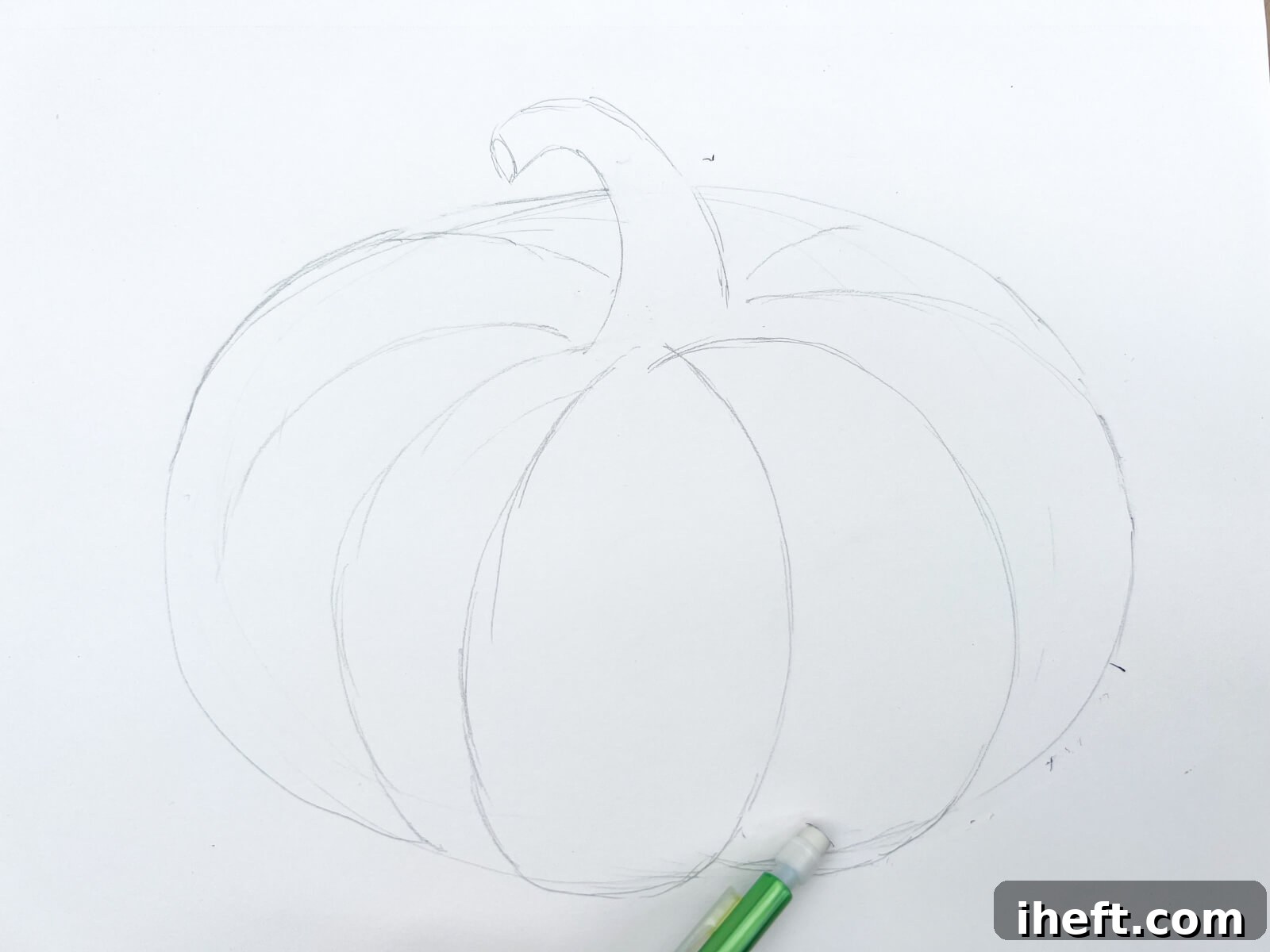 A green mechanical pencil erases sketch lines from a simple pumpkin pencil drawing.