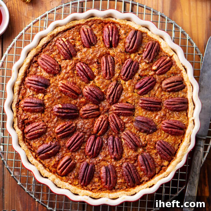 A beautifully baked pecan pie rests on a cooling rack, perfectly showcasing its golden crust and rich filling, ready for refrigeration or freezing. This image symbolizes the careful storage practices discussed.