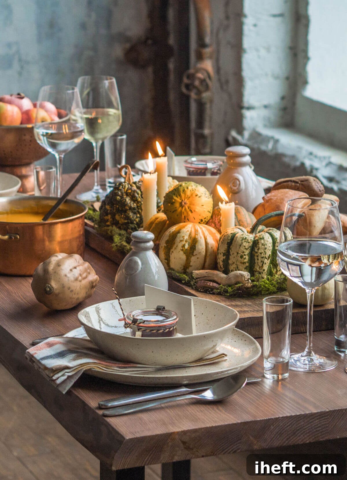 A charming rustic wood table beautifully adorned with natural stoneware place settings, various natural gourds, and a comforting pot of pumpkin soup, embodying a cozy and natural Thanksgiving color scheme.