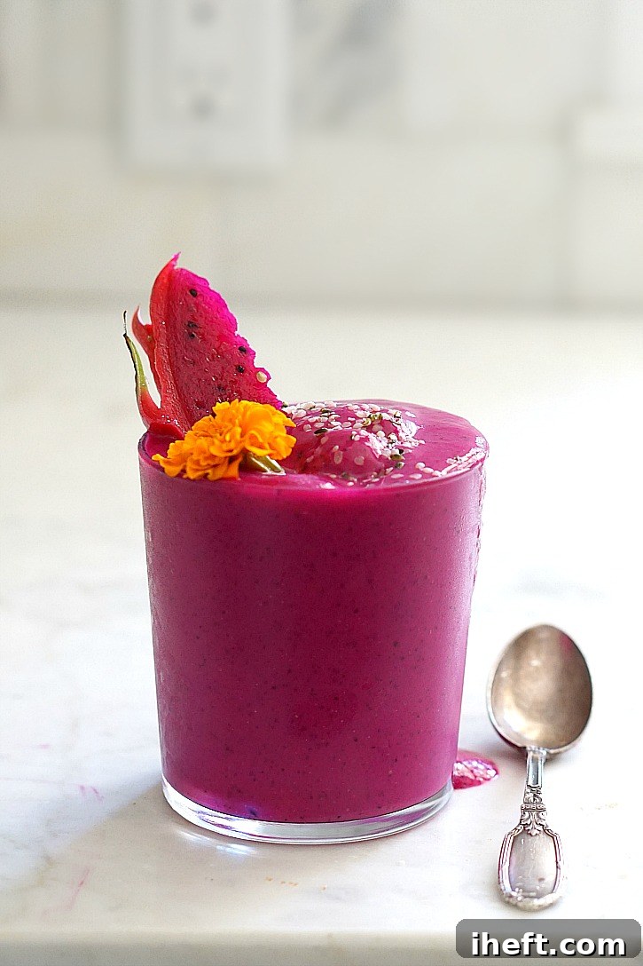 A beautifully vibrant dragon fruit or pitaya superfood smoothie, bursting with antioxidants and exotic flavor.
