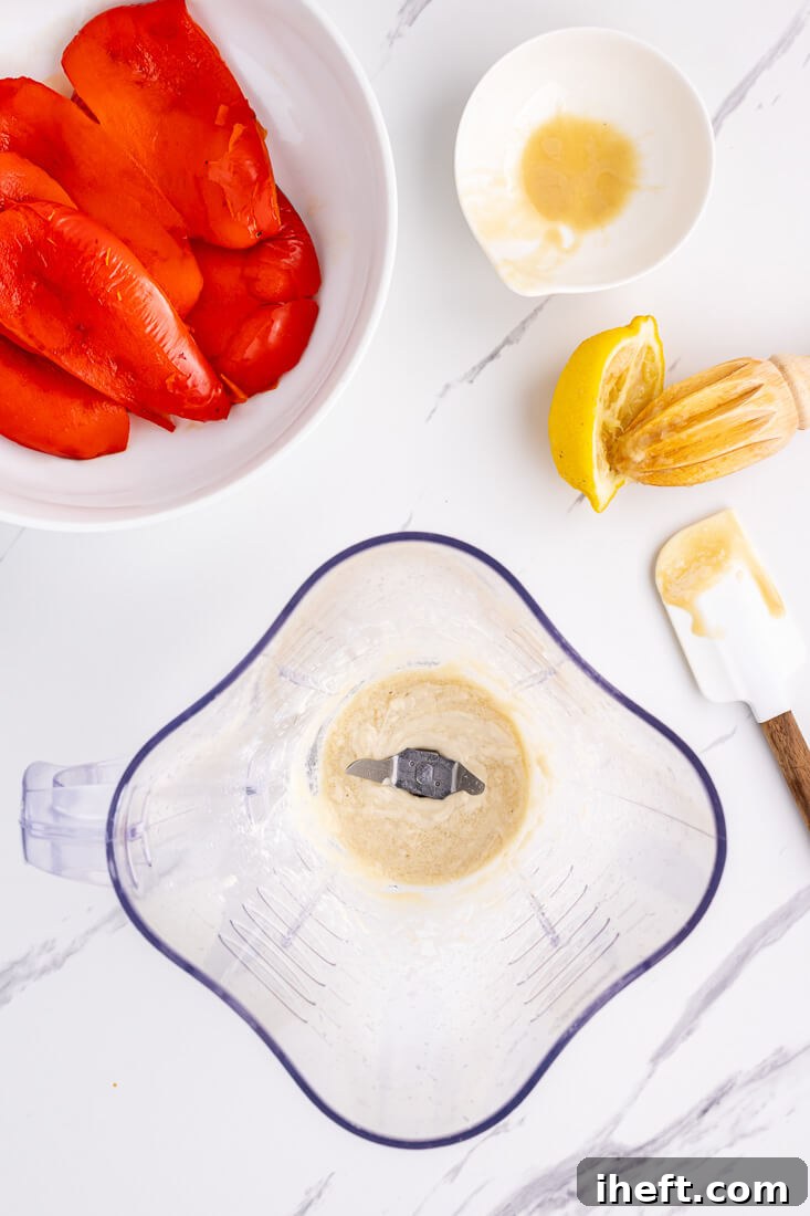 Tahini and lemon juice blended together in a blender to make hummus.
