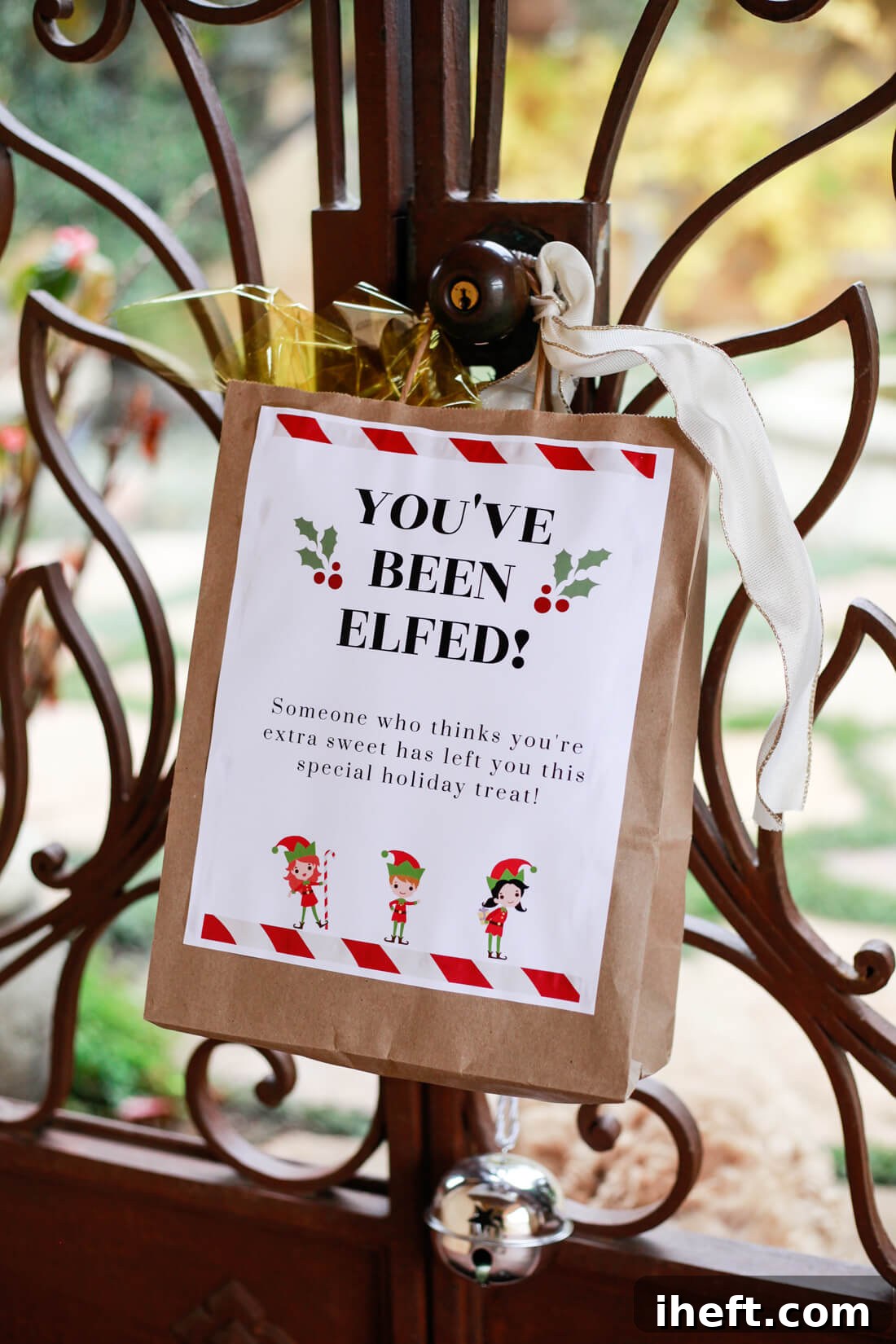 A You've Been Elfed bag hangs from a courtyard doorknob.