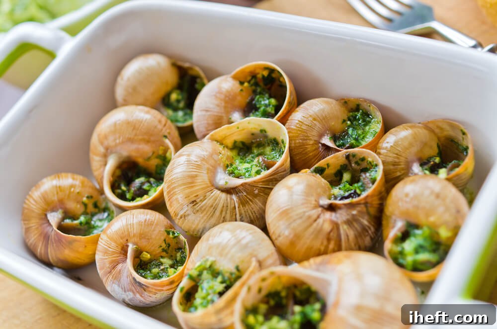 Escargots de Bourgogne (snails with parsley garlic butter) in a baking dish.