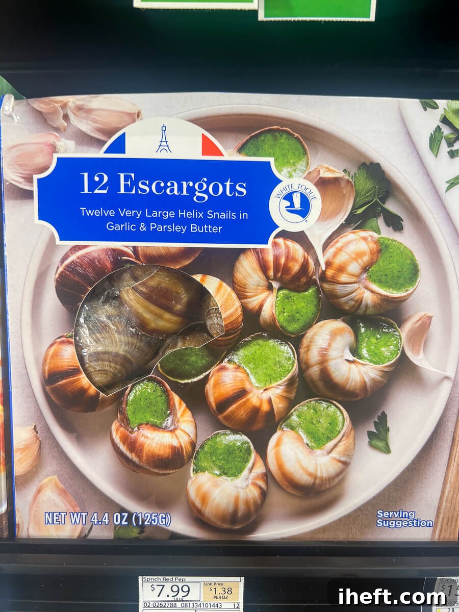 A frozen package of escargots in their shells, complete with parsley butter sauce, sits in the freezer aisle of a grocery store, ready for convenient home preparation.