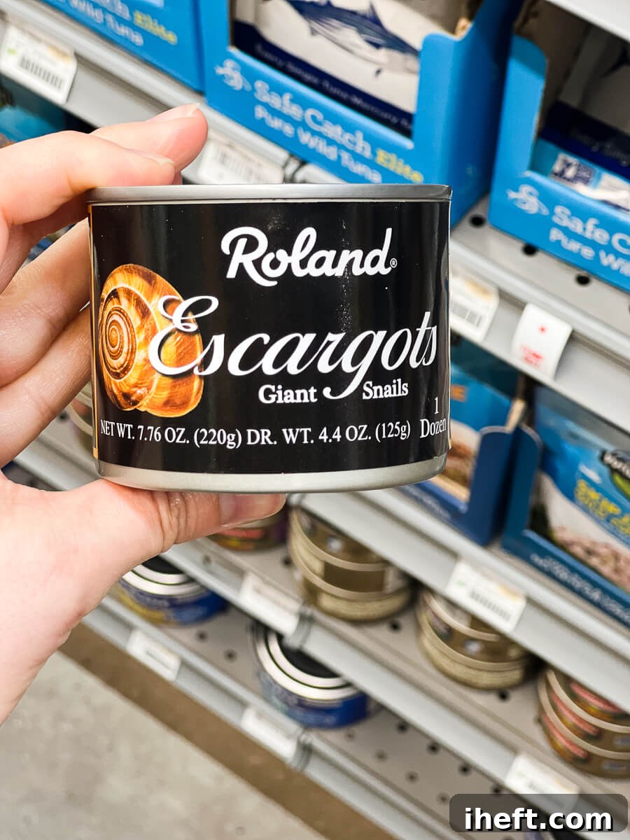 A can of Roland brand giant snails sits on a grocery store shelf, indicating a common source for home cooks preparing escargot.