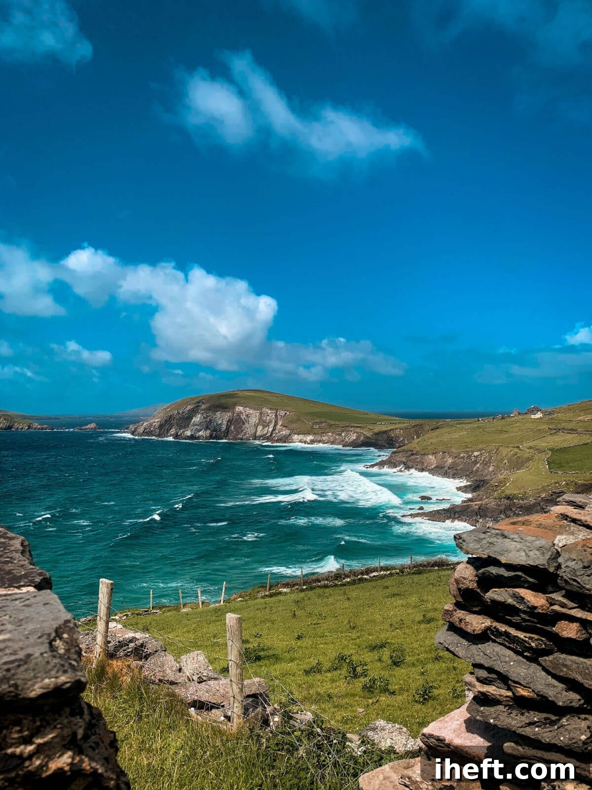 A beautiful, panoramic view of the rugged coast of Ireland, showcasing dramatic cliffs meeting the ocean.