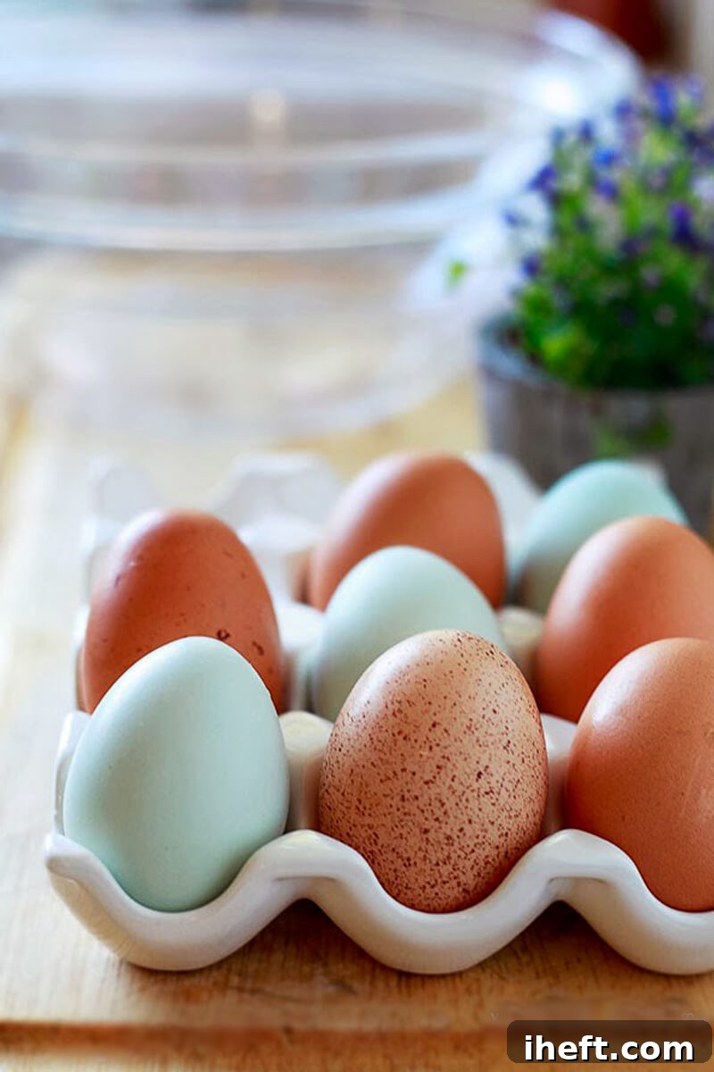 Freshly collected blue, brown, and white chicken eggs arranged beautifully.