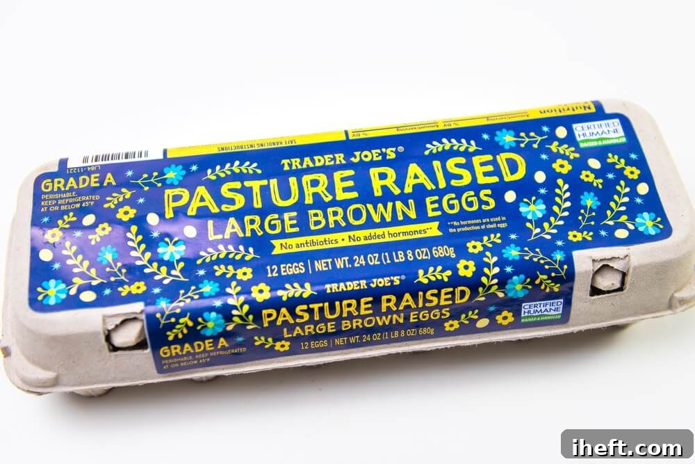 A carton of Trader Joe's Pasture Raised brown eggs. A Certified Humane label can be seen on the blue and yellow packaging. 