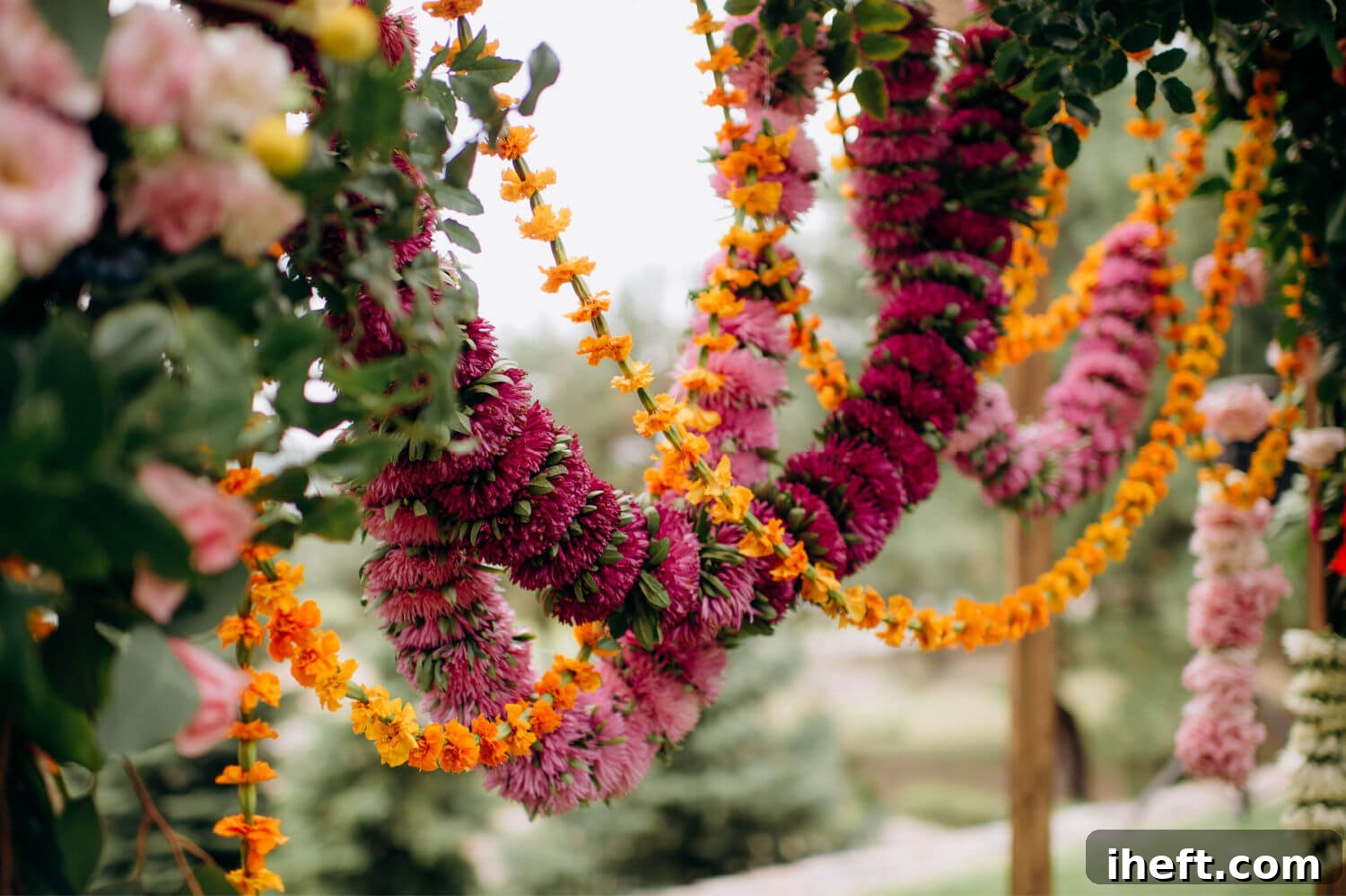 An elegant Mexican floral arrangement with strung pink and orange flowers. 