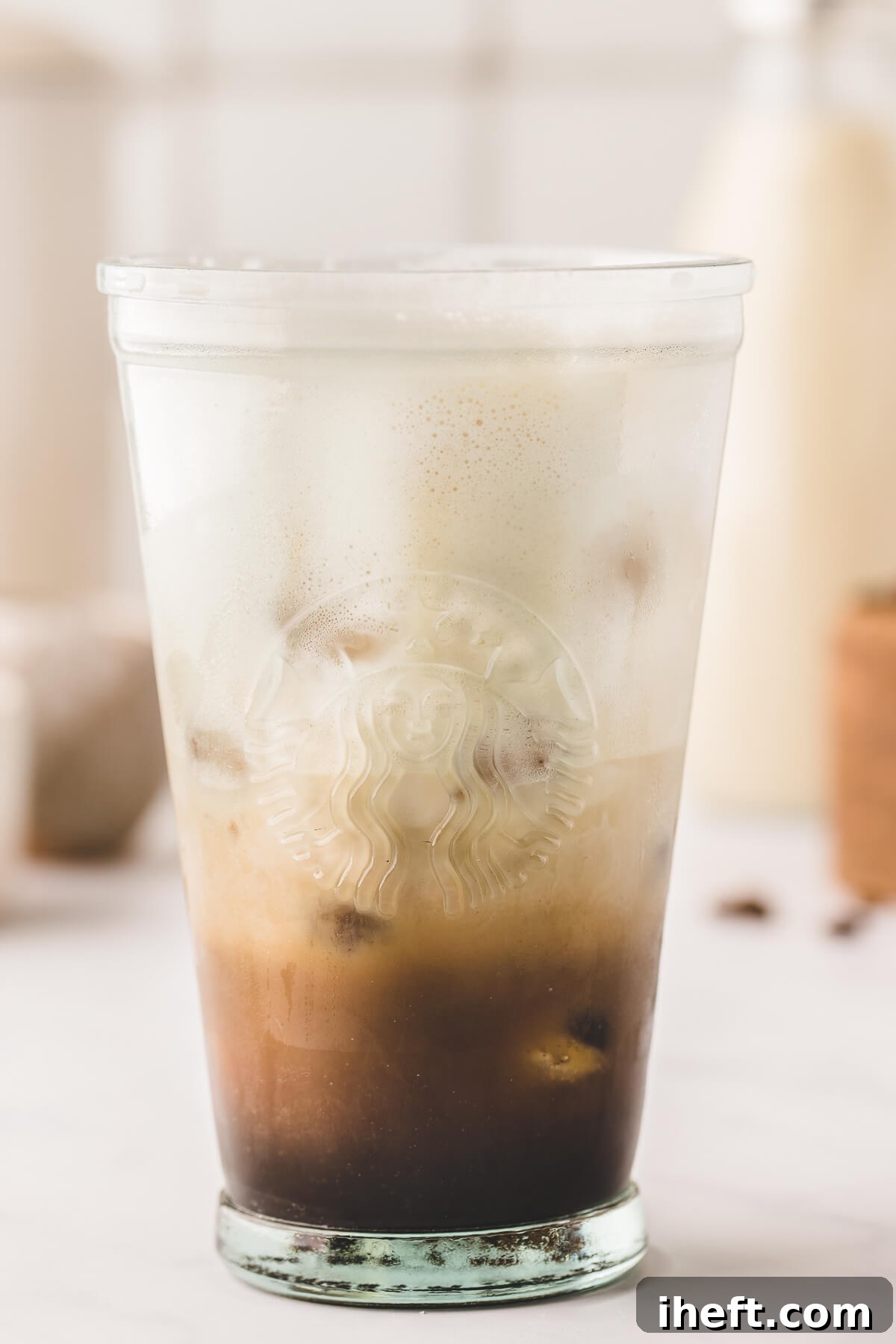 A homemade brown sugar oatmilk shaken espresso in a white kitchen.
