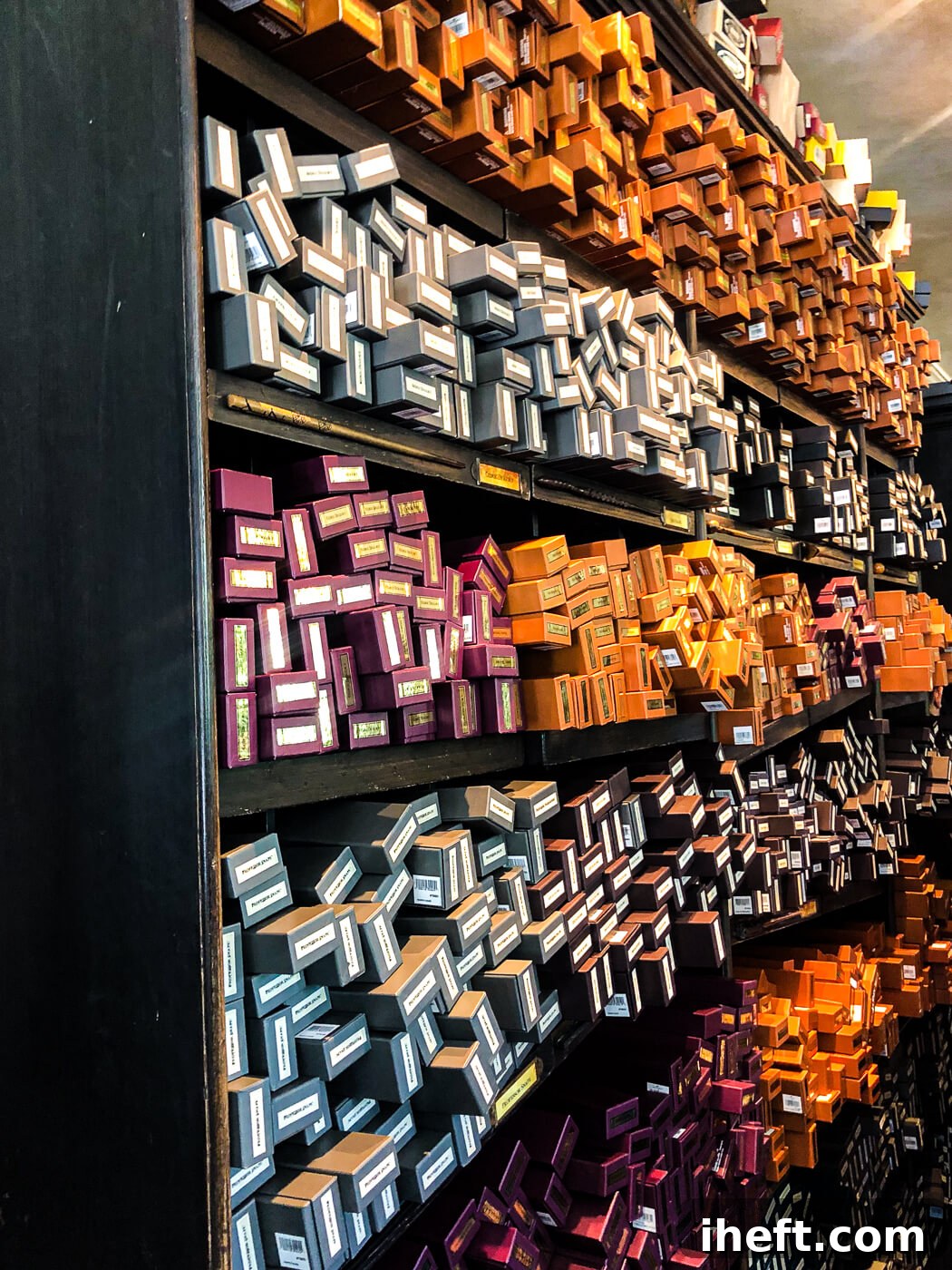 Shelves brimming with an array of Harry Potter themed magic wands, each awaiting its wizard at Ollivanders Wand Shop.