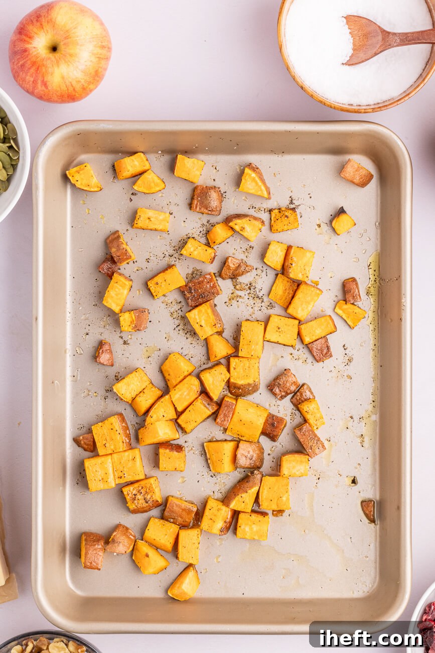 Sweet potato cubes roasted on a sheet pan.
