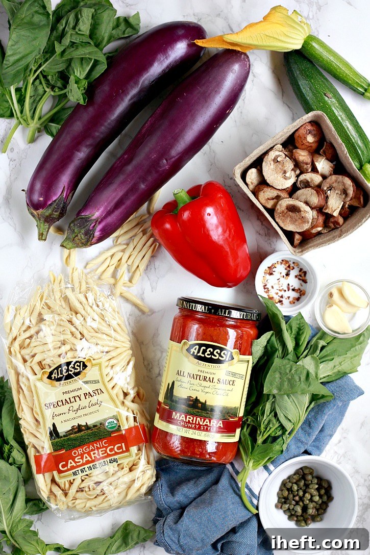 A vibrant selection of fresh ingredients including organic casarecci pasta, chunky marinara sauce, eggplant, red bell pepper, zucchini, mushrooms, and basil, ready for an easy summer vegetable pasta marinara.