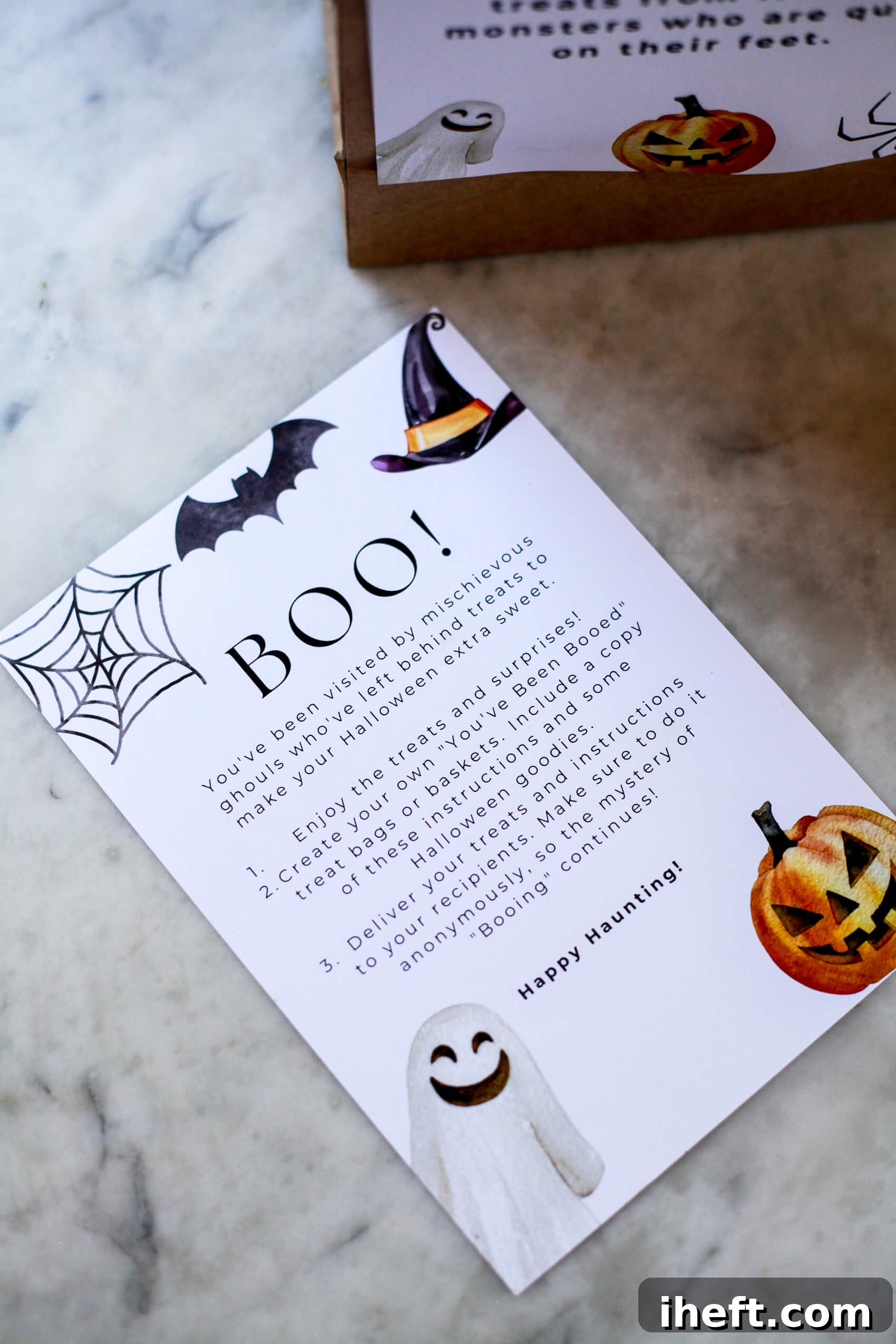 A free printable with you've been booed rules on a marble counter. 