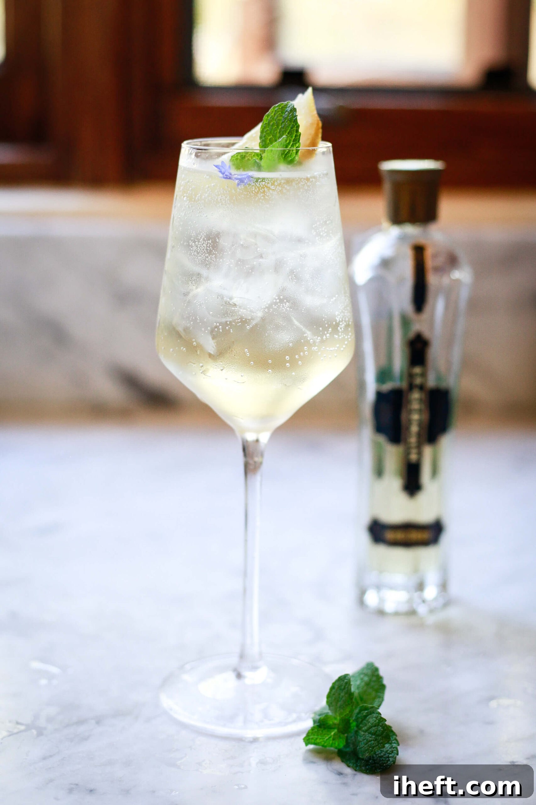 Hugo Spritz on a marble counter with St. Germain bottle in the background.