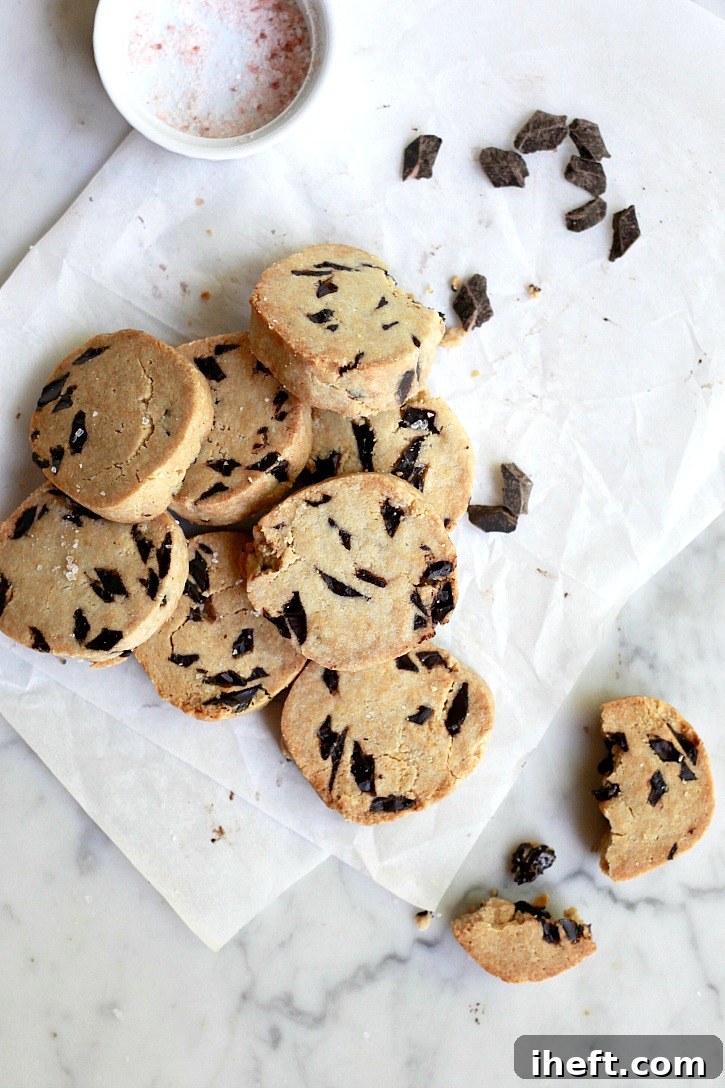 Beautifully sliced vegan paleo chocolate chip cookies, golden brown and studded with melty chocolate, ready to be enjoyed.