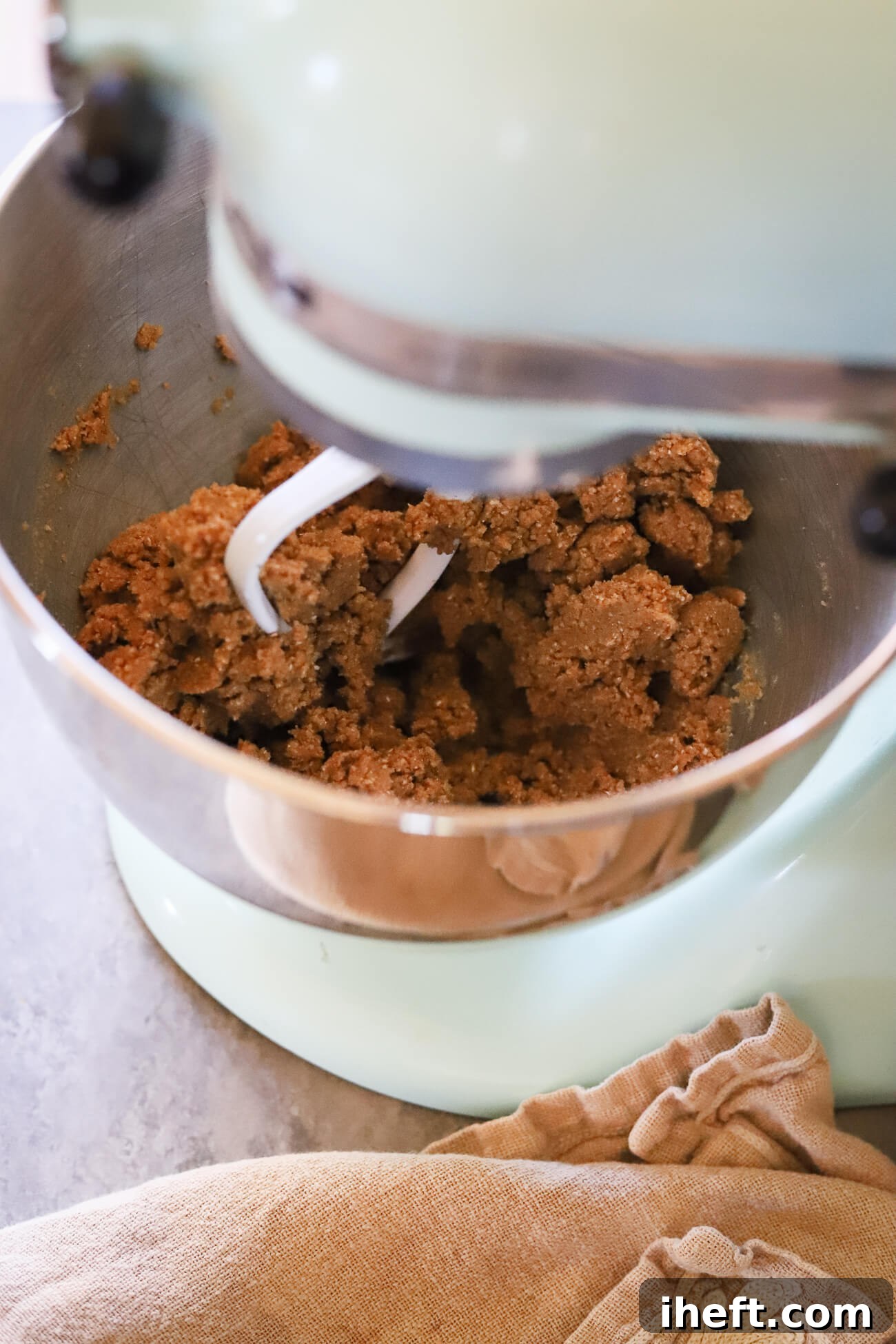 Oat flour peanut butter cookie dough being mixed in a Kitchenaid stand mixer.