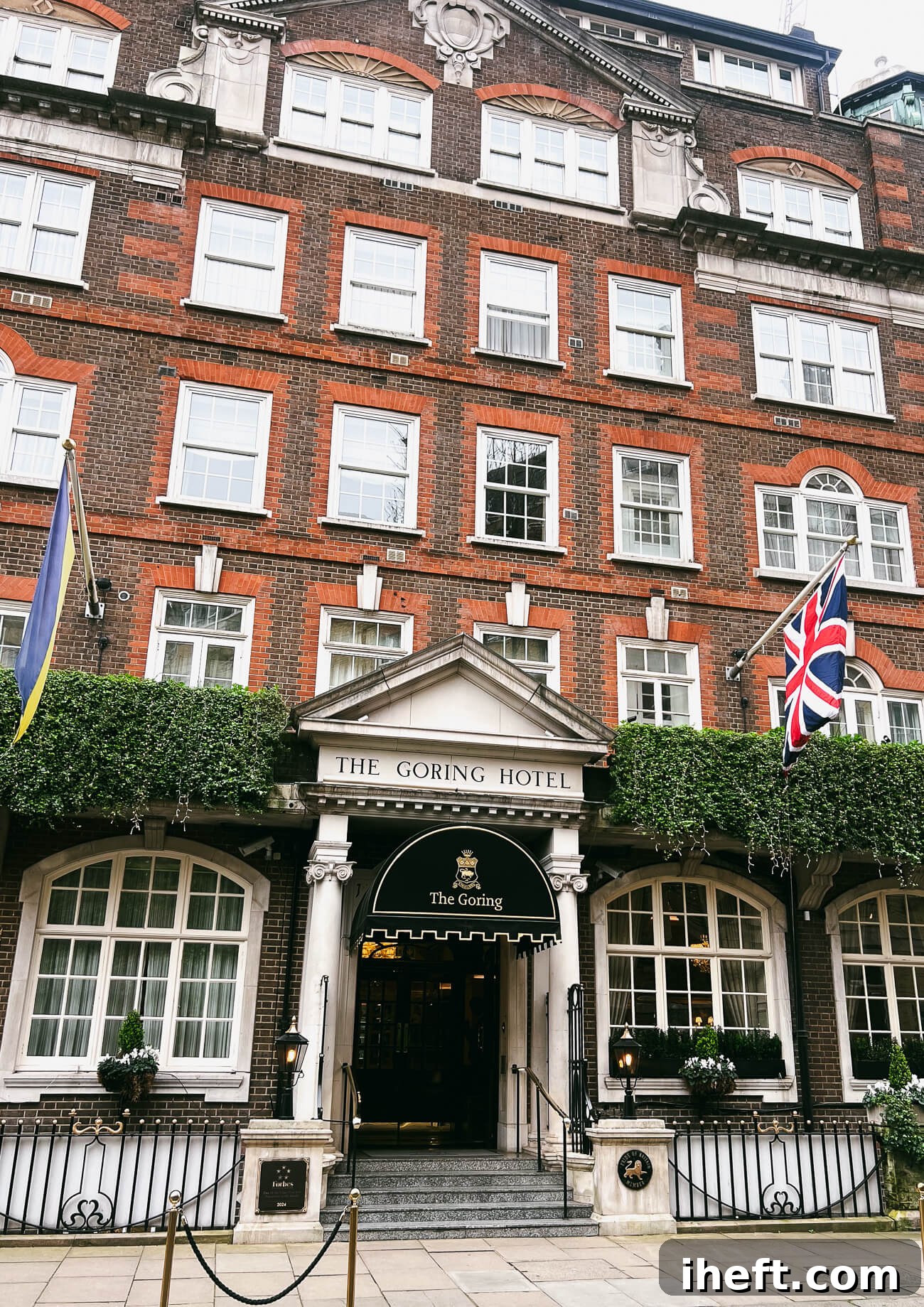 The facade of The Goring hotel in Belgravia London. A brick building with white windows and flags. A luxury 5-star hotel in London. 