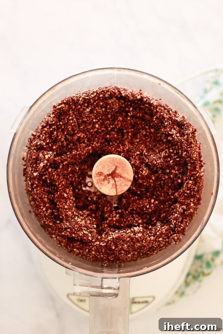 All ingredients for the chocolate bliss balls being processed together in a food processor until perfectly combined.