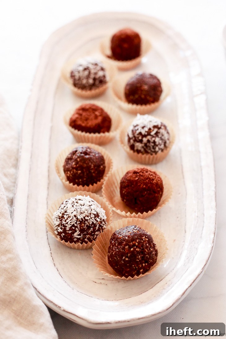 Beautifully coated cacao bliss balls with shredded coconut and a sprinkle of cacao powder, showcasing a healthier and delicious treat option.
