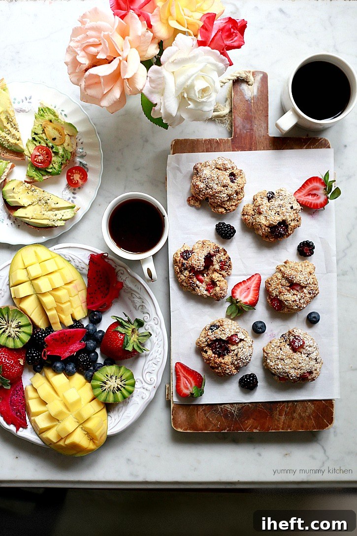 A beautiful brunch spread with tropical fruit, avocado toast, and homemade oatmeal scones, inviting a leisurely weekend meal.