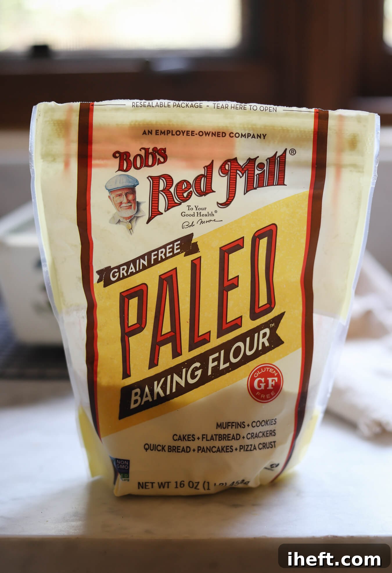 A bag of Bob's Red Mill Grain Free Paleo Baking Flour sits on a white kitchen counter to be used in healthy recipes. 