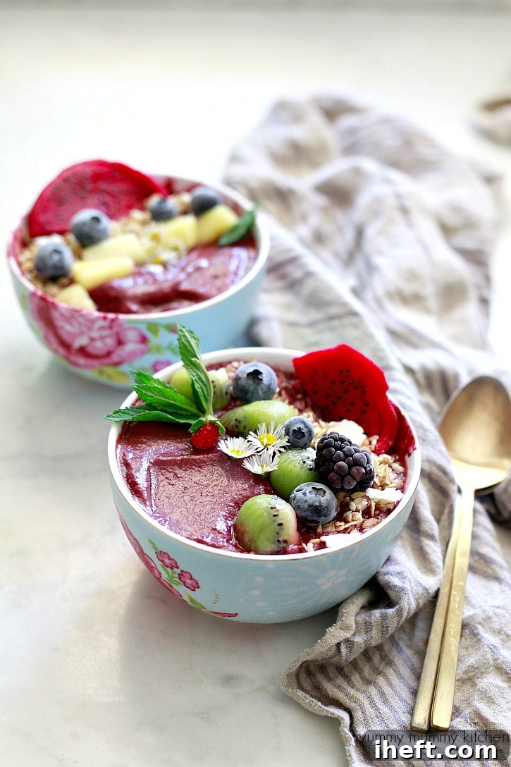 Exquisite acai bowls generously topped with crunchy granola and fresh, colorful berries, ready to be enjoyed.