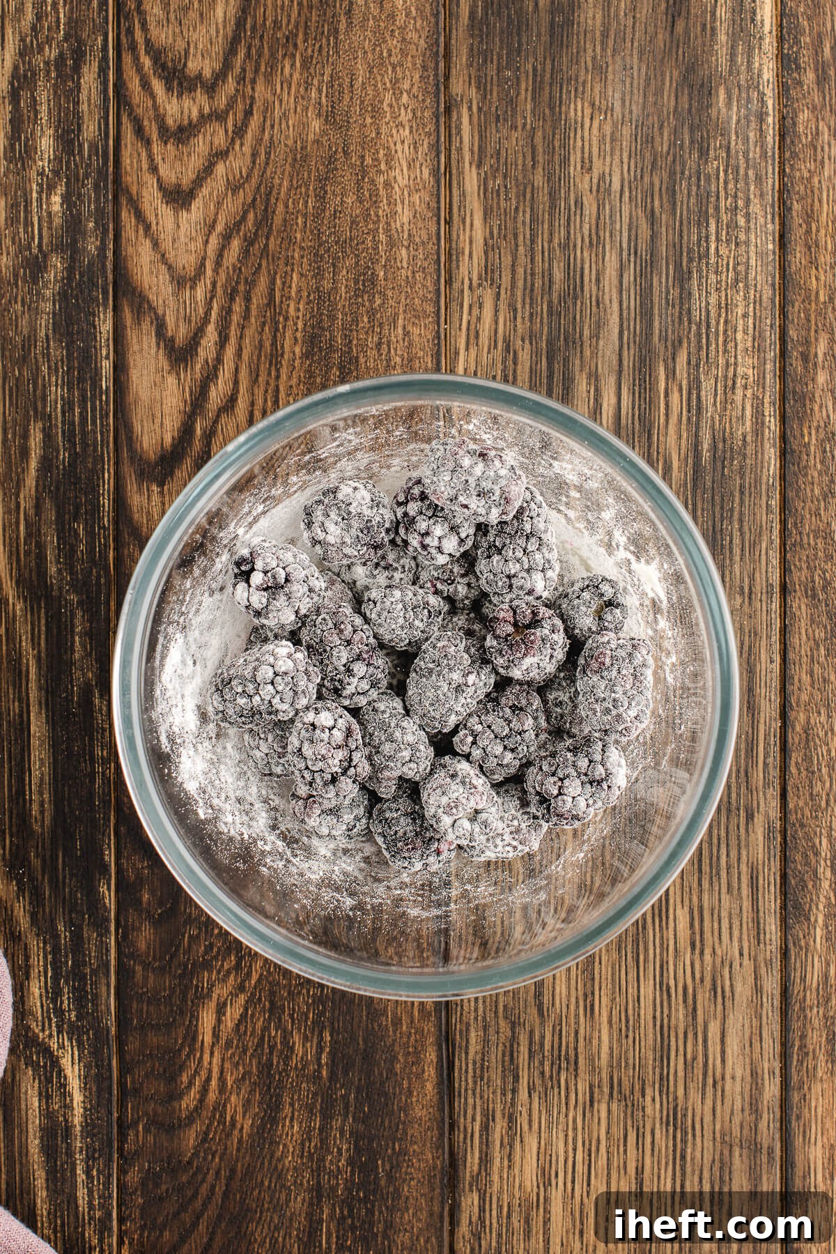 A small bowl of fresh blackberries coated in flour.