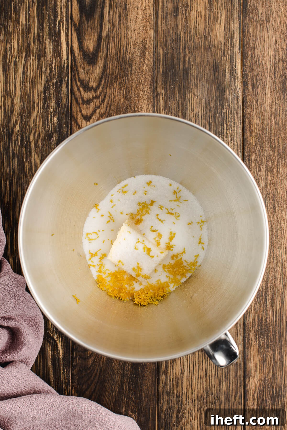 Sugar, butter, and lemon zest in a stand mixer to begin making coffee cake.