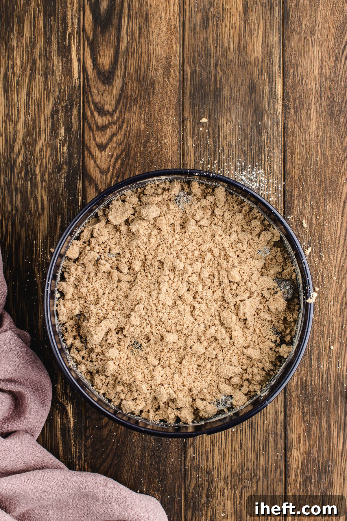 Coffee cake topped with brown sugar streusel in a springform pan before baking.