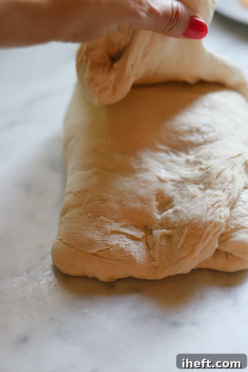 Shaping jalapeno cheddar sourdough bread into a battard.