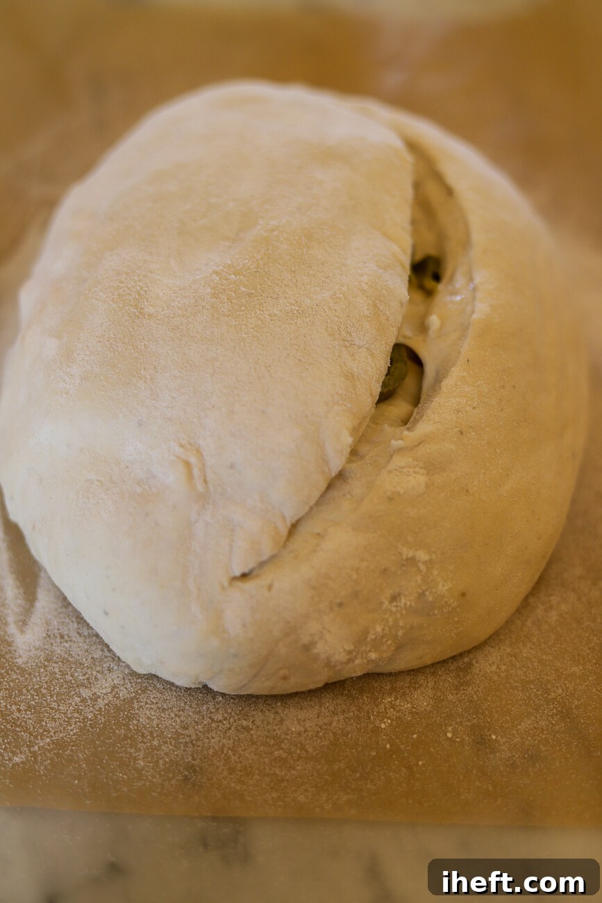 Jalapeno Cheddar sourdough bread dough with a simple score.