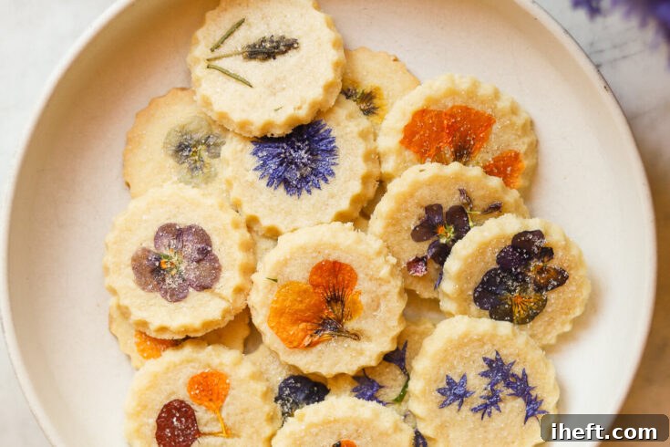 Edible pressed flower cookies. Round shortbread cookies topped with edible pressed flowers and sprinkled with sugar.