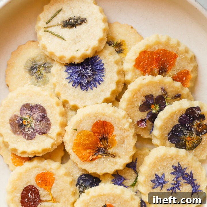 Edible pressed flower cookies. Round shortbread cookies topped with edible pressed flowers and sprinkled with sugar.