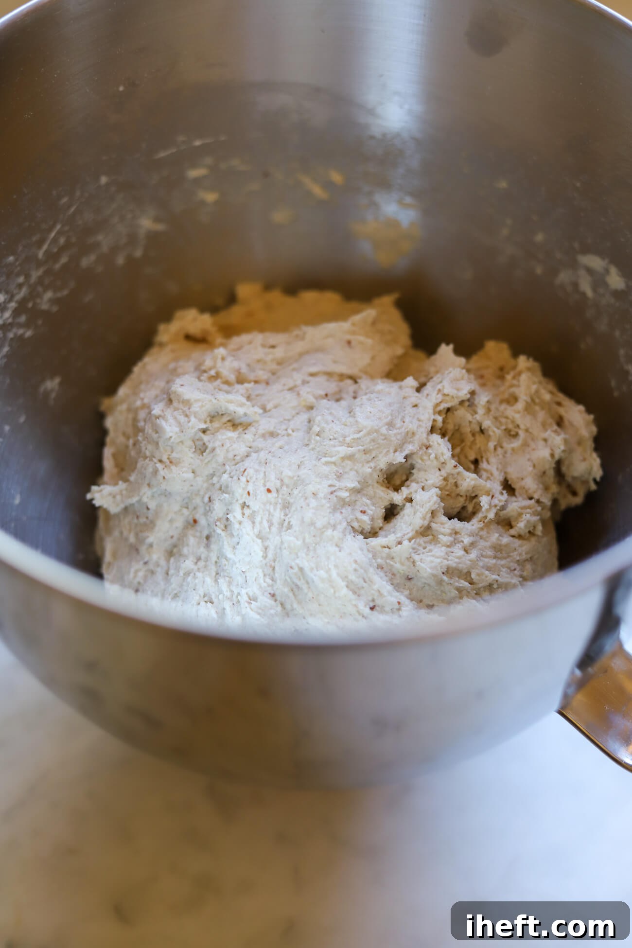 The dough for gluten-free sourdough bread in a KitchenAid mixer.