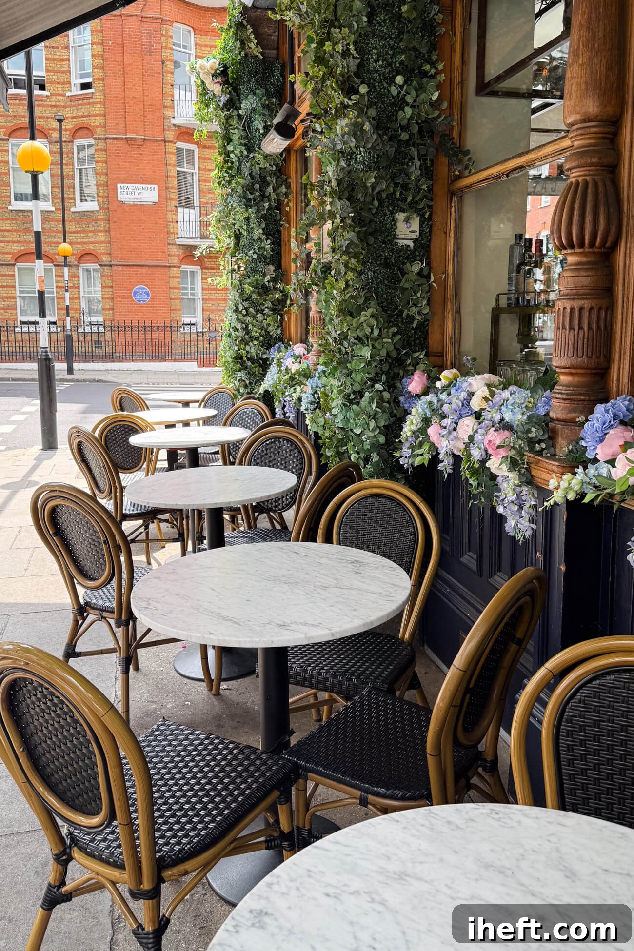The beautiful exterior of The Cavendish, a classic pub in Marylebone, adorned with an abundance of vibrant flowers, enhancing its charming street presence.