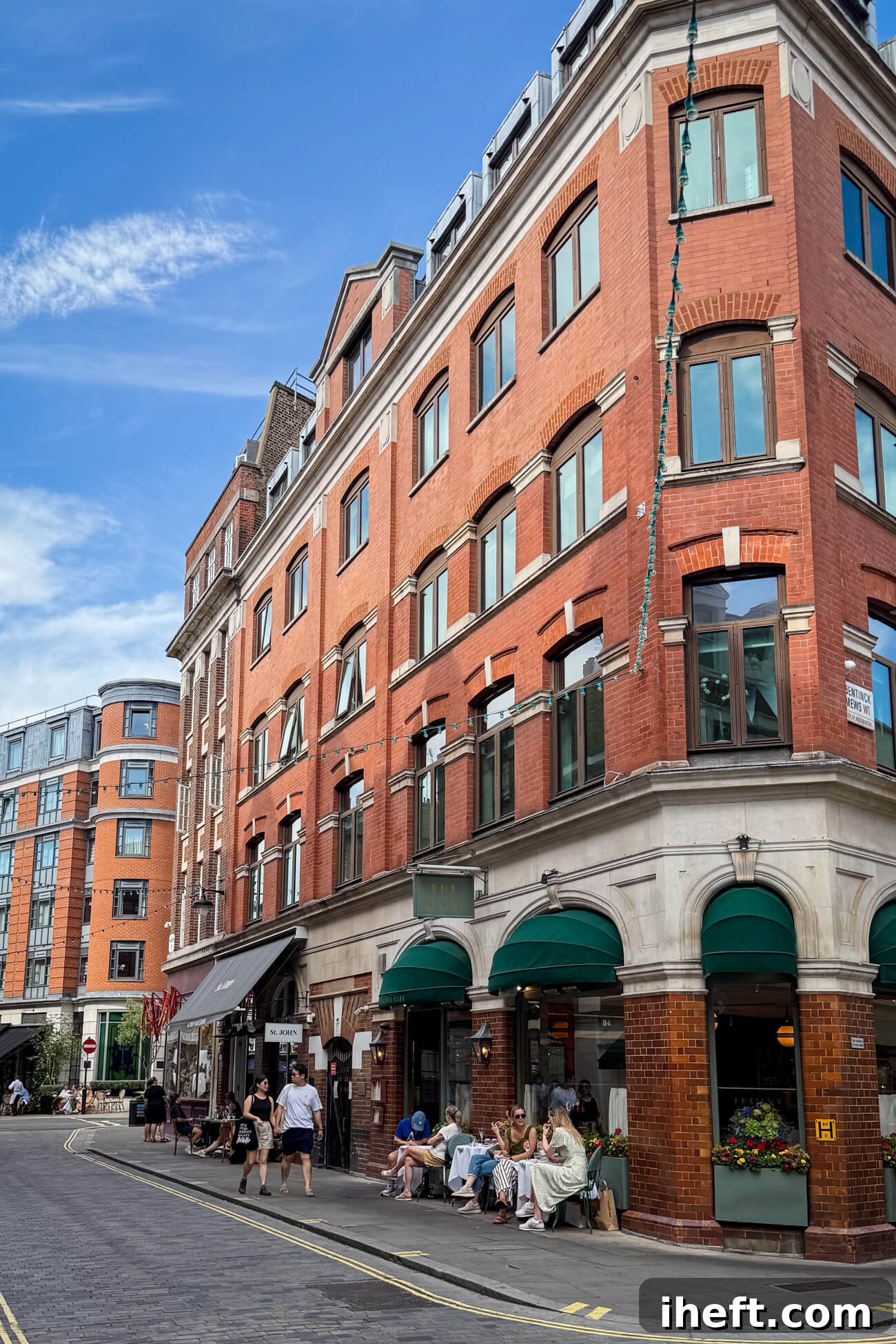 People enjoy outdoor dining at The Ivy and St. John restaurants, contributing to the lively atmosphere of charming Marylebone village in London.