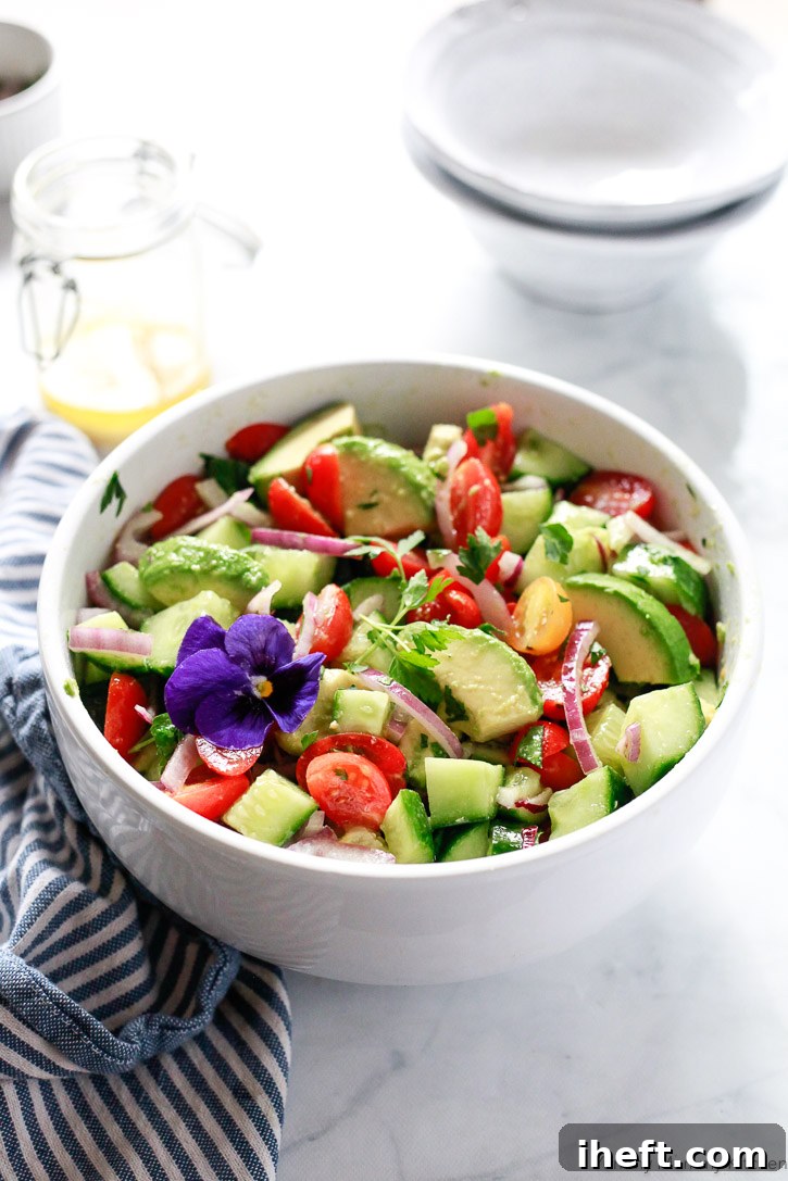 A visually appealing bowl of avocado, tomato, and cucumber salad. This hearty and delicious recipe is naturally vegan and gluten-free, making it a healthy and inclusive choice for everyone.