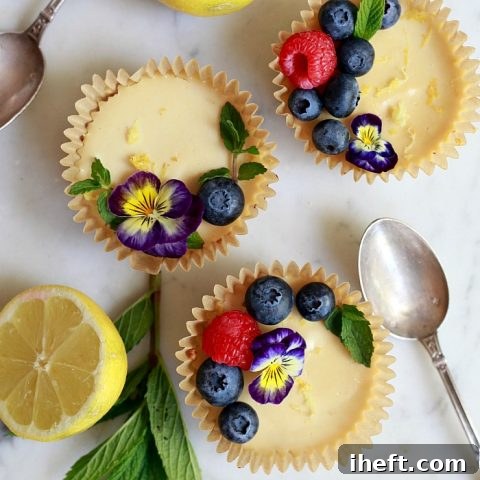 Beautiful lemon tarts topped with berries and edible flowers.