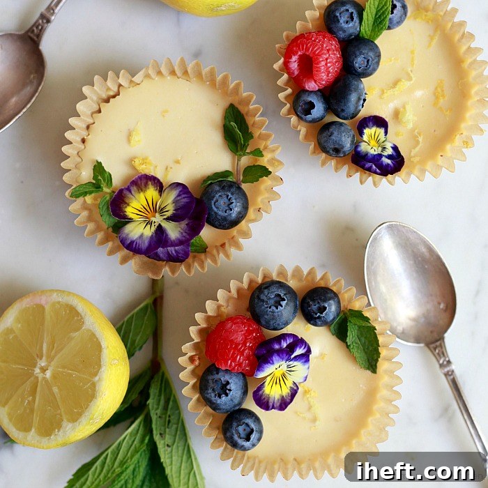 Beautiful lemon tarts topped with berries and edible flowers. Perfect for spring and summer celebrations.