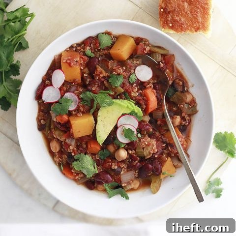 Slow Cooker Vegan Chili with Quinoa and Butternut Squash, garnished with fresh cilantro and avocado