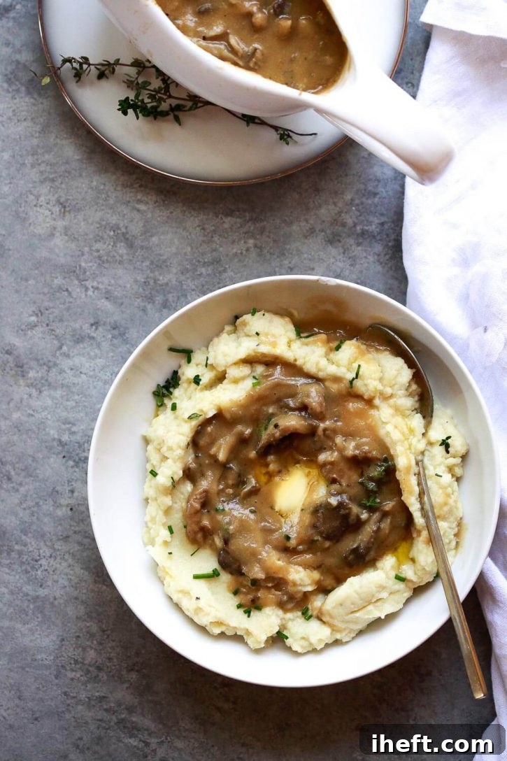 Rich and savory vegan mushroom gravy in a gravy boat, ready to pour.