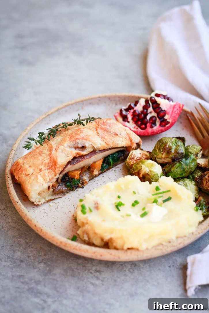 A stunning Vegetarian Wellington, elegantly sliced and ready to serve, revealing layers of savory filling.