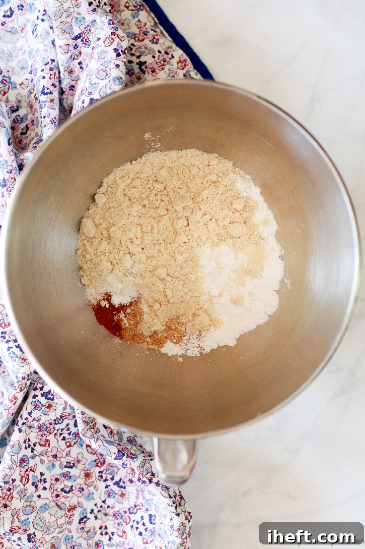 Essential ingredients for wholesome gluten-free gingerbread cookies, including almond flour, arrowroot starch, aromatic cinnamon, and warming ginger.