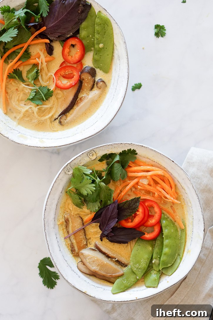 A vibrant bowl of curry soup with colorful vegetables, showcasing a delicious and wholesome vegan meal option.