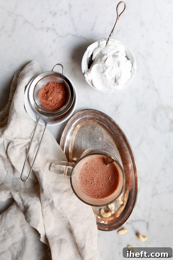 This easy vegan paleo hot chocolate is made with cashews and cacao, blended to perfection for a creamy texture.